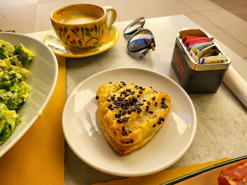 Nutella pastry beside a foamy cappuccino