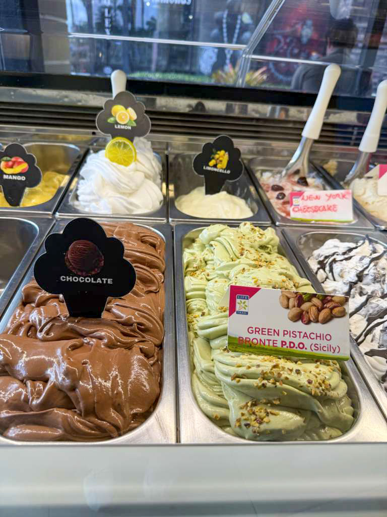 Display of homemade gelato — pistacchio Bronte, lemon, limoncello, chocolate, mango, NY cheesecake