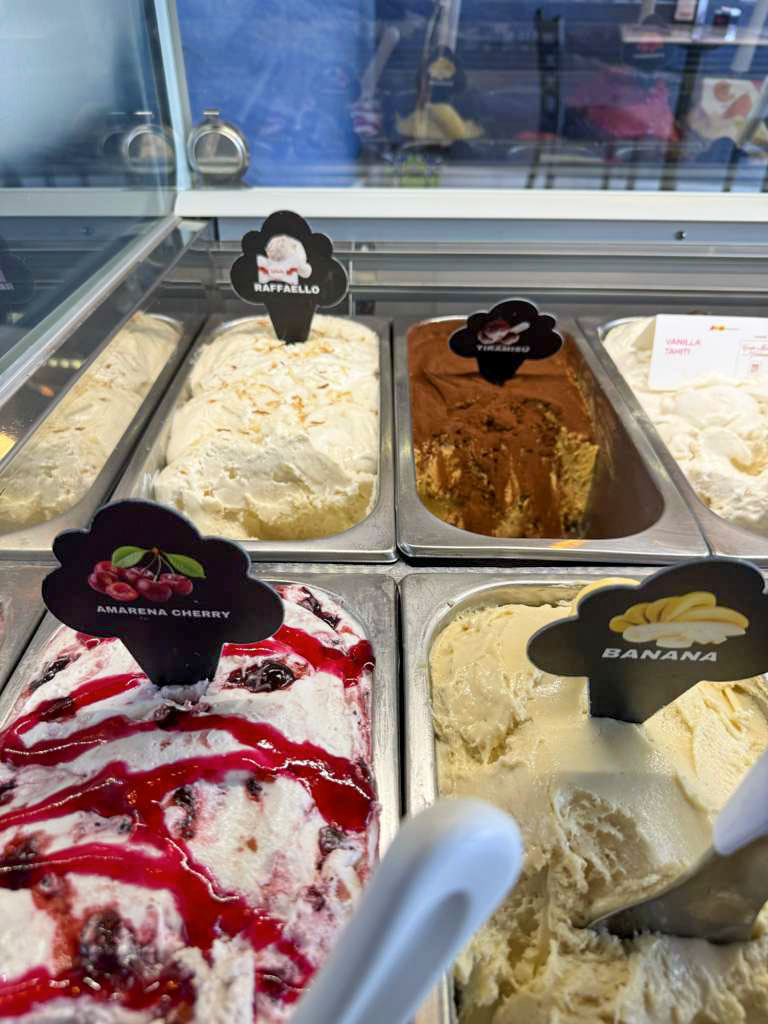 Gelato display showing Raffaello, Tiramisù, Vanilla Tahiti, Amarena Cherry and Banana flavors