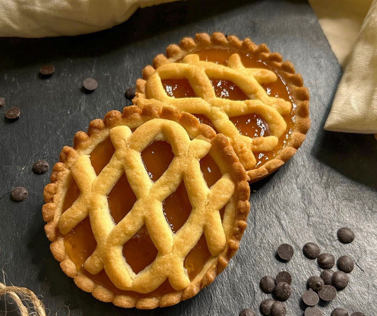 Two homemade apricot tartlets with lattice crust